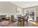 Bright dining area with wood floors and sliding glass doors to the outside at 1565 S Helena Cir, Aurora, CO 80017