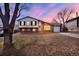Charming split-level home with a brick and siding exterior, well-kept lawn and an attached garage at 1565 S Helena Cir, Aurora, CO 80017