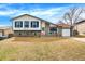 Charming split-level home with a brick and siding exterior, well-kept lawn and an attached garage at 1565 S Helena Cir, Aurora, CO 80017