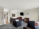 Inviting living room featuring dark grey carpet, neutral walls, and cozy seating arrangement at 1565 S Helena Cir, Aurora, CO 80017