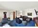 Comfortable living room featuring blue carpet, neutral walls, and contemporary furnishings with a television at 1565 S Helena Cir, Aurora, CO 80017