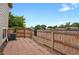 Backyard featuring brick pavers, a wood fence, and a partial view of mature trees at 1276 S Zeno Cir # A, Aurora, CO 80017