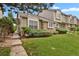 Inviting townhome with stone accents, lush landscaping, and a pathway leading to the front entrance at 1276 S Zeno Cir # A, Aurora, CO 80017