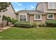 Charming townhome featuring a well-maintained lawn and stone facade, creating a welcoming curb appeal at 1276 S Zeno Cir # A, Aurora, CO 80017