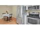 Functional kitchen featuring stainless steel appliances, white cabinets, and adjacent dining area at 1276 S Zeno Cir # A, Aurora, CO 80017