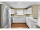 Bright kitchen features stainless steel appliances, white cabinets, and wood flooring at 1276 S Zeno Cir # A, Aurora, CO 80017