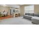 Open concept living space featuring plush seating, neutral tones, and an adjacent kitchen area at 1276 S Zeno Cir # A, Aurora, CO 80017