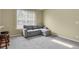 Comfortable room with neutral carpet and gray couch at 1276 S Zeno Cir # A, Aurora, CO 80017