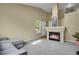 Cozy living room with a fireplace, neutral carpet, and large windows for natural light at 1276 S Zeno Cir # A, Aurora, CO 80017