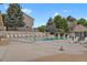 Community pool with plenty of lounge chairs surrounded by mature landscaping and well-maintained buildings at 1276 S Zeno Cir # A, Aurora, CO 80017