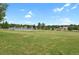 An expansive green field with a fenced-in sports court, surrounded by trees and neighborhood homes at 1276 S Zeno Cir # A, Aurora, CO 80017