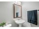 Small bathroom with pedestal sink, mirror, and towel rack at 677 N 48Th Ave, Brighton, CO 80601