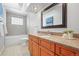 Bathroom with a large mirror, granite countertop, soaking tub, and tiled floor at 7250 W Vassar Ave, Lakewood, CO 80227