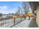 Inviting deck offering outdoor living space with snow-covered planks and backyard views at 7250 W Vassar Ave, Lakewood, CO 80227