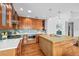 Well-equipped kitchen with a central island, modern appliances, and custom wood cabinetry at 7250 W Vassar Ave, Lakewood, CO 80227