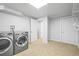 Bright laundry room featuring a modern washer and dryer set, and access to extra storage at 7250 W Vassar Ave, Lakewood, CO 80227