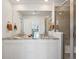 Bathroom featuring double vanity, granite countertop, and a glass-enclosed shower with neutral tile at 1649 Marquette Aly, Erie, CO 80516