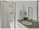 Bathroom with a glass enclosed shower, white vanity, and modern fixtures at 1649 Marquette Aly, Erie, CO 80516