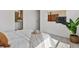 Bright bedroom featuring neutral decor, modern wall art, and a glimpse into a well-lit bathroom at 1649 Marquette Aly, Erie, CO 80516