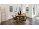 Bright dining area with wood floors, a round table and a full bank of windows at 1649 Marquette Aly, Erie, CO 80516