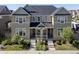 A well-maintained townhome with a gray roof, neat landscaping, and inviting front porches at 1649 Marquette Aly, Erie, CO 80516
