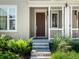 Inviting front entrance with a brown door, white trim, and well-maintained landscaping at 1649 Marquette Aly, Erie, CO 80516