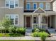 Charming townhome featuring a covered porch and well-kept lawn at 1649 Marquette Aly, Erie, CO 80516