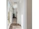 Bright entry hallway with natural light, wood floors, and convenient coat closet at 1649 Marquette Aly, Erie, CO 80516