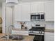 Modern kitchen with white cabinets, stainless steel appliances and subway tile backsplash at 1649 Marquette Aly, Erie, CO 80516