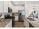 Modern kitchen with stainless steel appliances, granite countertops and wood flooring at 1649 Marquette Aly, Erie, CO 80516