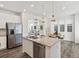 Bright, open kitchen featuring an island with a sink, and modern appliances at 1649 Marquette Aly, Erie, CO 80516
