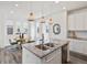 Open kitchen featuring a granite island, pendant lighting, and stainless steel appliances at 1649 Marquette Aly, Erie, CO 80516