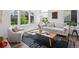 Sun-lit living room featuring modern decor and large windows with natural light at 1649 Marquette Aly, Erie, CO 80516