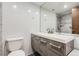 Contemporary bathroom featuring a sleek vanity with grey wood grain finish and a shower with marbled tile surround at 790 N Washington St # 804, Denver, CO 80203