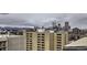 Panoramic city view showcasing a skyline with several modern buildings, all with snow-capped mountains in the background at 790 N Washington St # 804, Denver, CO 80203