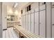 Locker room area featuring a wooden bench, multiple lockers, and a vanity with mirrors at 790 N Washington St # 804, Denver, CO 80203