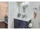 Stylish bathroom features a vanity with a navy blue cabinet and white countertop at 7198 Eaton Ct, Arvada, CO 80003
