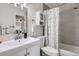 Modern bathroom features a single sink vanity, tiled shower, and neutral color scheme at 7198 Eaton Ct, Arvada, CO 80003