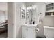 Clean bathroom featuring a single sink vanity, mirrored cabinet, and built-in storage at 7198 Eaton Ct, Arvada, CO 80003