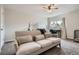 Cozy bedroom featuring carpet floors, a sofa, a ceiling fan, and a window at 7198 Eaton Ct, Arvada, CO 80003