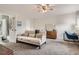 Bedroom with carpet, sofa, cieling fan, mirror, dresser and a private bathroom at 7198 Eaton Ct, Arvada, CO 80003