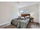 Comfortable bedroom featuring a large window, neutral color scheme, and ceiling fan at 7198 Eaton Ct, Arvada, CO 80003