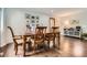 Dining room with a rustic wooden table, hardwood floors, and neutral walls at 7198 Eaton Ct, Arvada, CO 80003