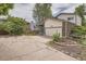 Driveway leading to a house with brick accents and a large garage at 7198 Eaton Ct, Arvada, CO 80003