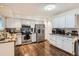 Kitchen with white cabinets, stainless steel appliances, and hardwood floors at 7198 Eaton Ct, Arvada, CO 80003