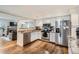 Kitchen with white cabinets, stainless steel appliances, and hardwood floors at 7198 Eaton Ct, Arvada, CO 80003