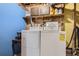 Finished laundry room with washer, dryer, and storage shelves at 7198 Eaton Ct, Arvada, CO 80003