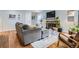 Comfortable living room with a brick fireplace, hardwood floors, and lots of natural light at 7198 Eaton Ct, Arvada, CO 80003