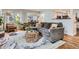Cozy living room featuring hardwood floors, a plush gray sofa, and lots of natural light at 7198 Eaton Ct, Arvada, CO 80003