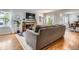 Comfortable living room with a brick fireplace, hardwood floors, and backyard view at 7198 Eaton Ct, Arvada, CO 80003